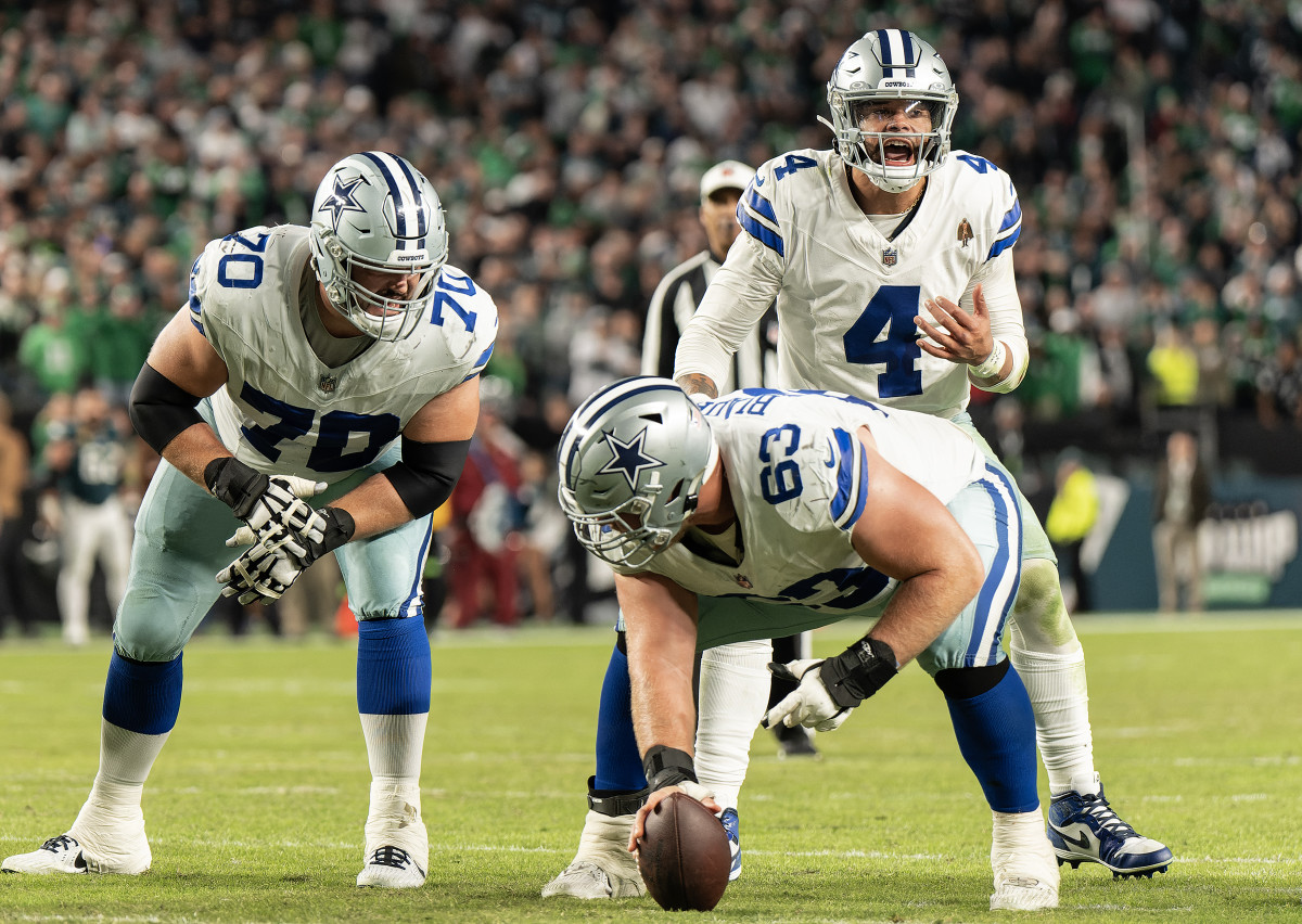 Dak Prescott yells as he leans over to catch a snap from the  Cowboys’ center